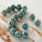 12 Packs: 17 ct. (204 total) Turquoise Ceramic Round Melon Beads, 10mm by Bead Landing™